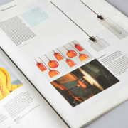 An open magazine spread featuring a large image of a yellow knitted textile on the left page and images of pendant lights and glassblowing on the right page, accompanied by text.
